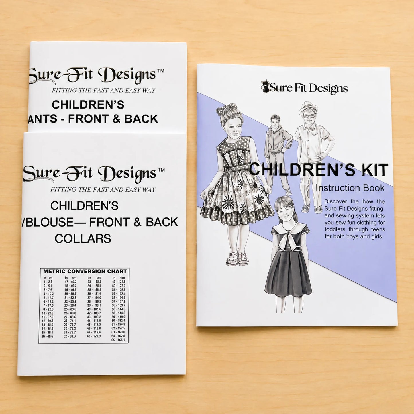 Children's Kit contents, patterns and an instruction book on a maple table