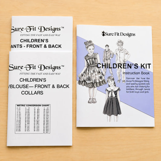 Children's Kit contents, patterns and an instruction book on a maple table
