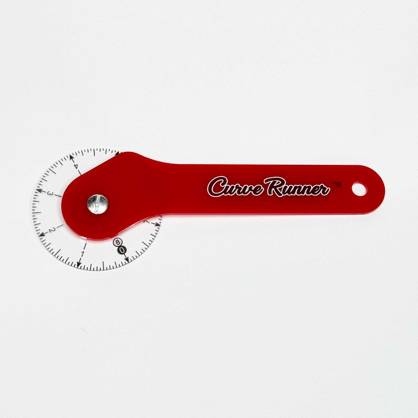 a hand held measuring device for measuring sewing pattern curves.  It has a red handle and the words in black ink that say Curve Runner,  the ruler has a transparent wheel with black inches measured around the wheel.