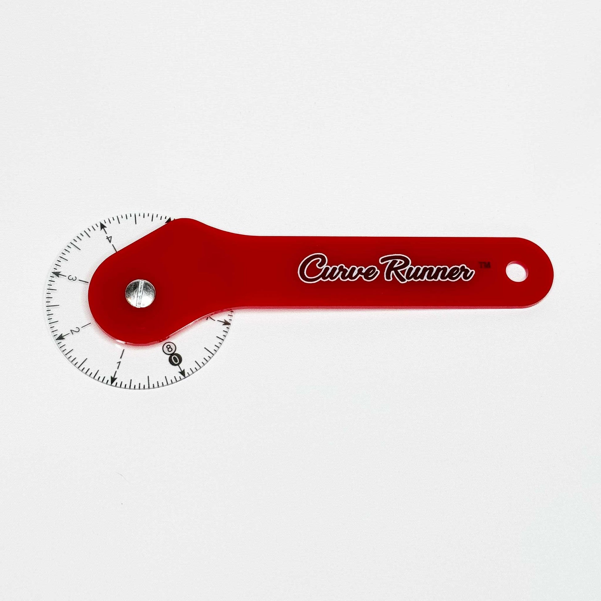 a hand held measuring device for measuring sewing pattern curves.  It has a red handle and the words in black ink that say Curve Runner,  the ruler has a transparent wheel with black inches measured around the wheel.