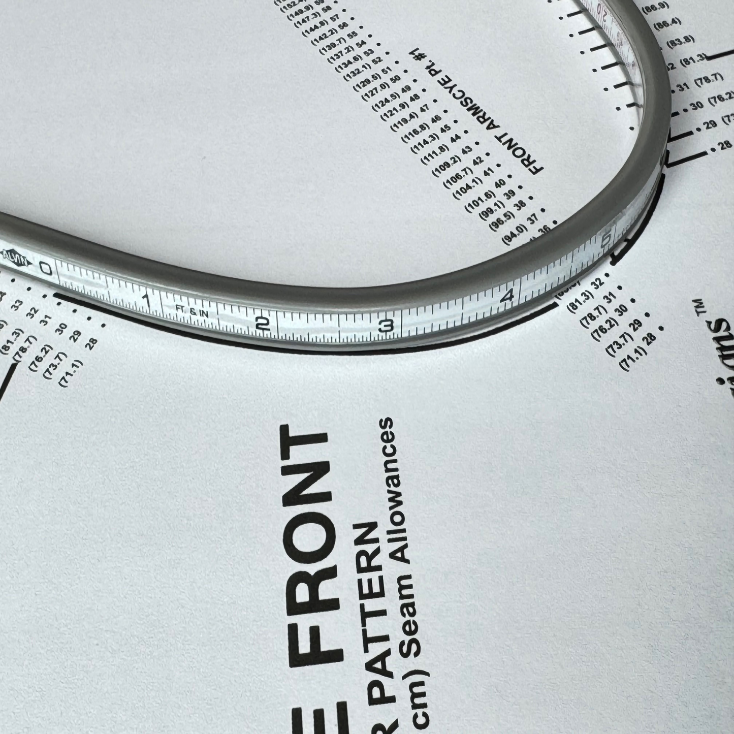 An aluminum flexible ruler that is placed on top of Sure Fit Designs' bodice pattern along the armhole curve
