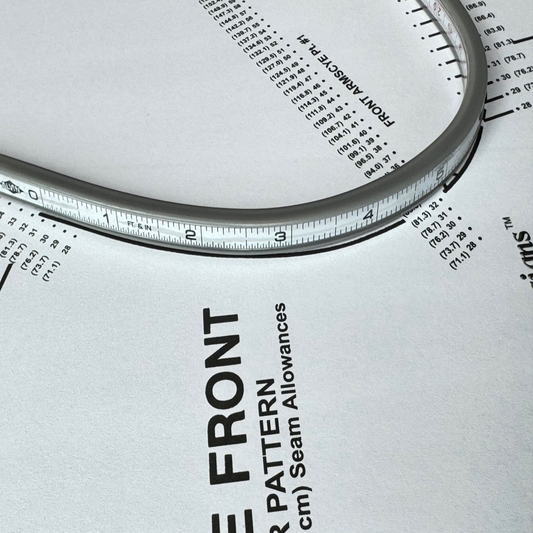 An aluminum flexible ruler that is placed on top of Sure Fit Designs' bodice pattern along the armhole curve