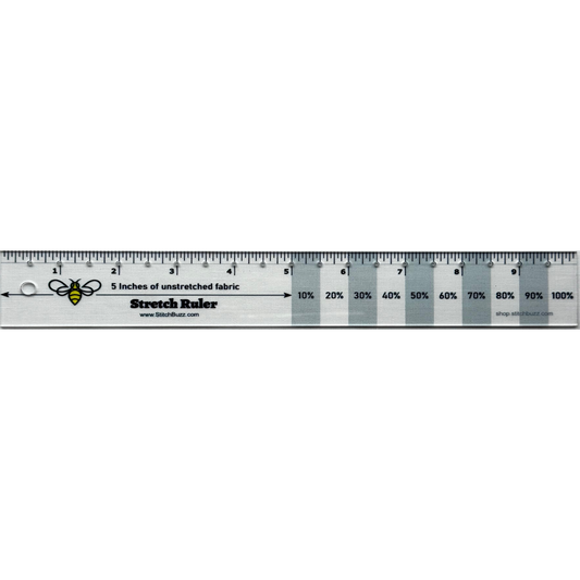 A 10 inch clear plastic ruler with gray stripes every other inch, used to measure the stretch and recovery of knit fabrics