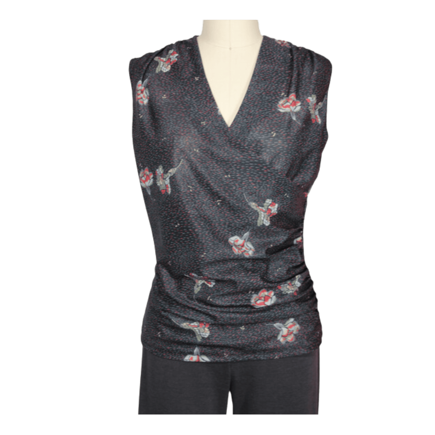 A black crossover top for women on a mannequin. the top is made of lightweight black fabric with red flowers and green leaves