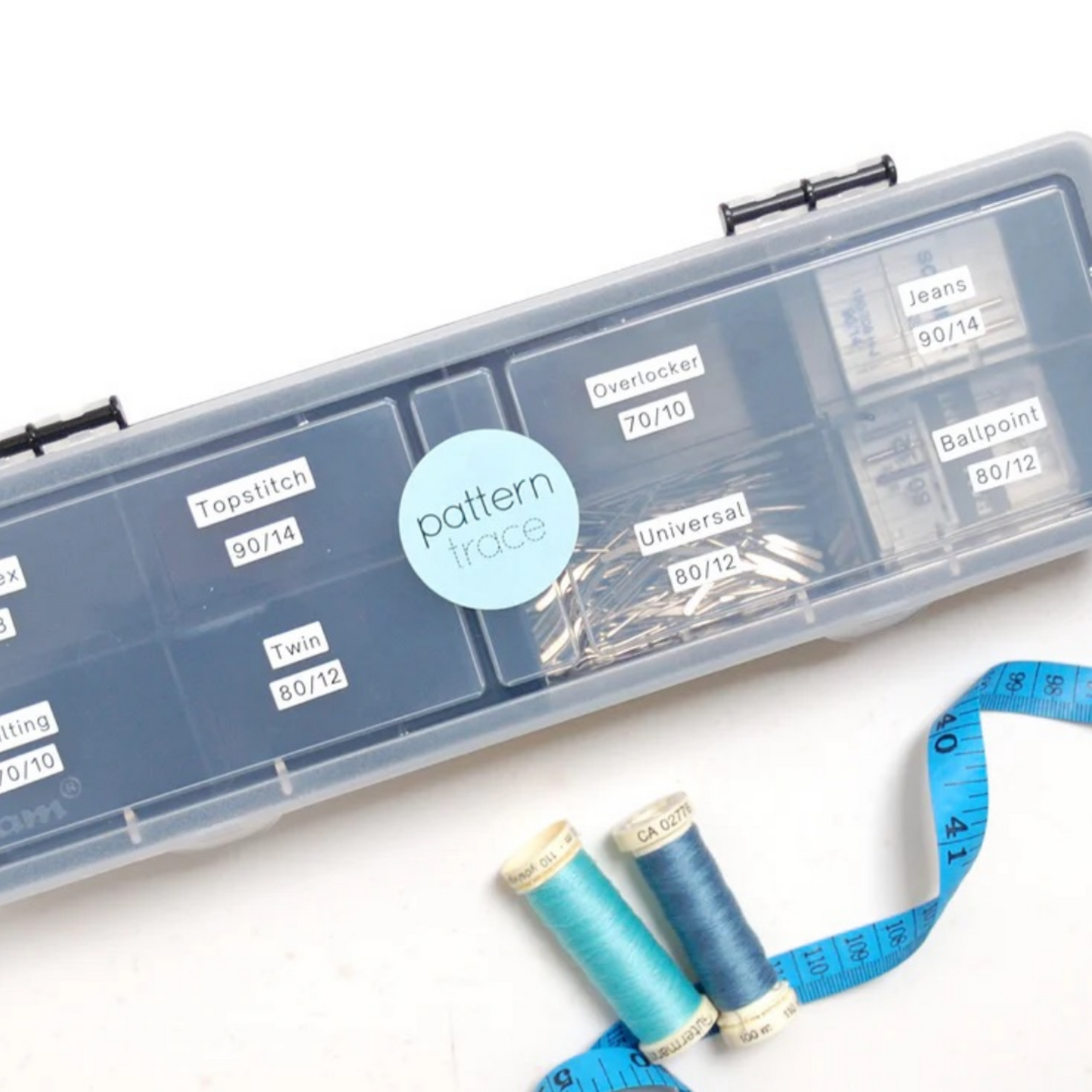 a gray plastic box with a clear lid for storing sewing needles