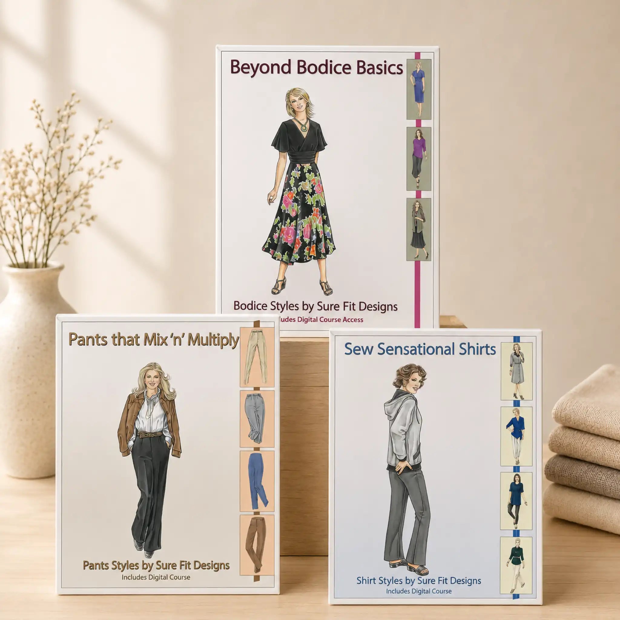 Three garment designing books for bodice, pants, and shirt designing displayed on a warm, light maple table