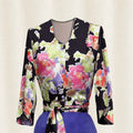 Colorful floral-patterned top with long sleeves on a light background