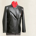 Black leather jacket on a mannequin with a red shirt underneath against a beige background