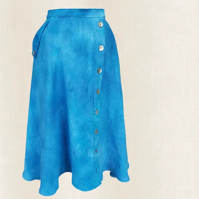 Blue skirt with button details on a beige background