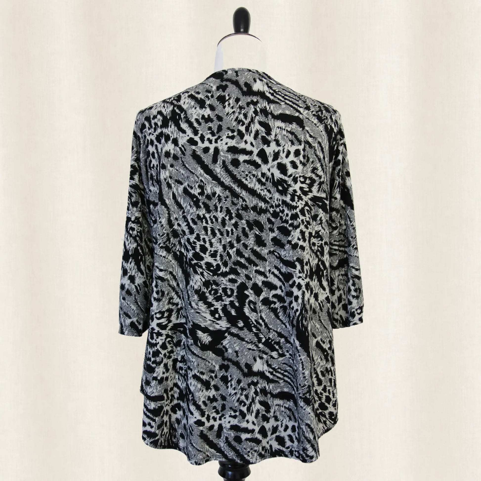 Leopard print cardigan back view on a mannequin against a plain background