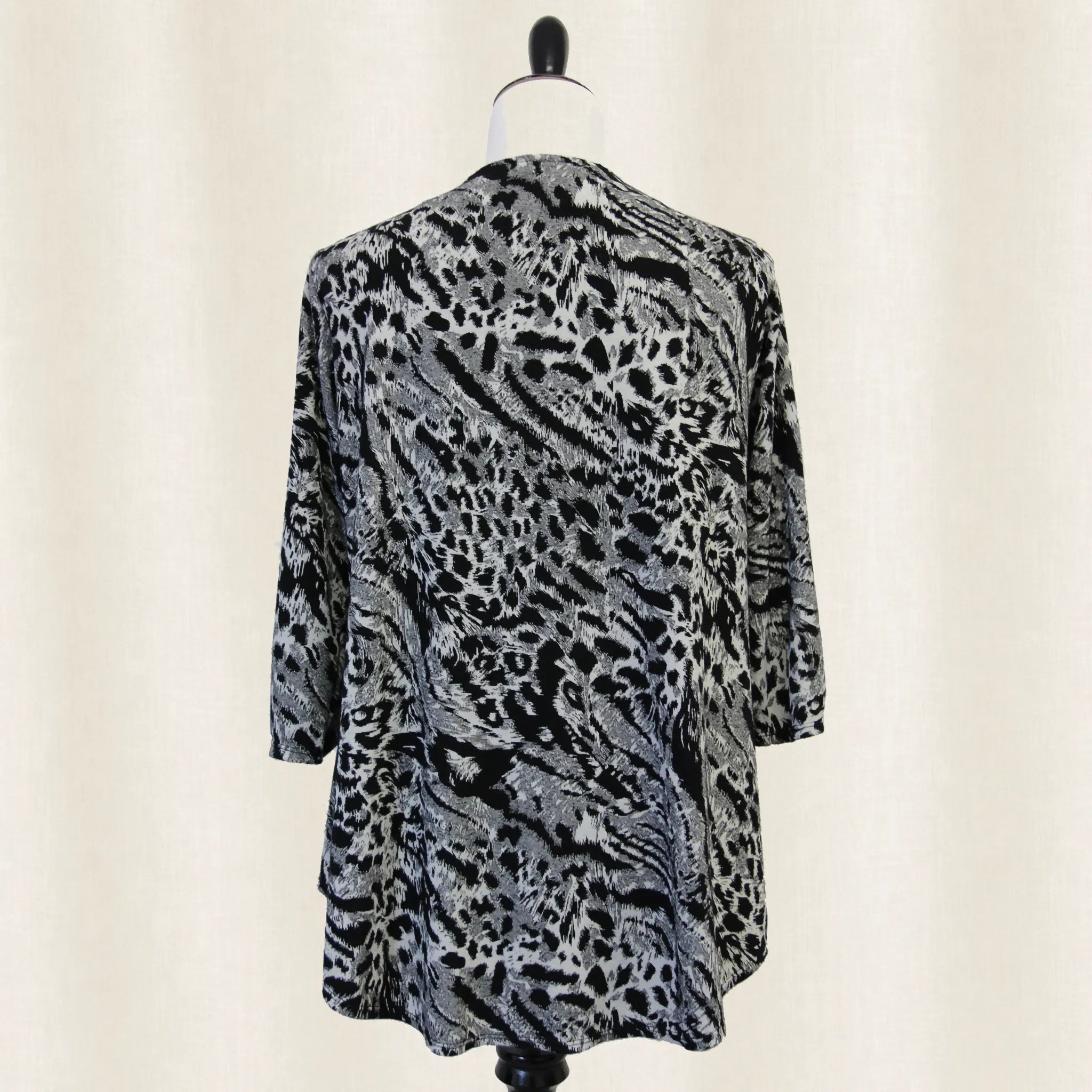 Leopard print cardigan back view on a mannequin against a plain background