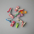 Colorful plastic clips arranged in a circular pattern on a gray background