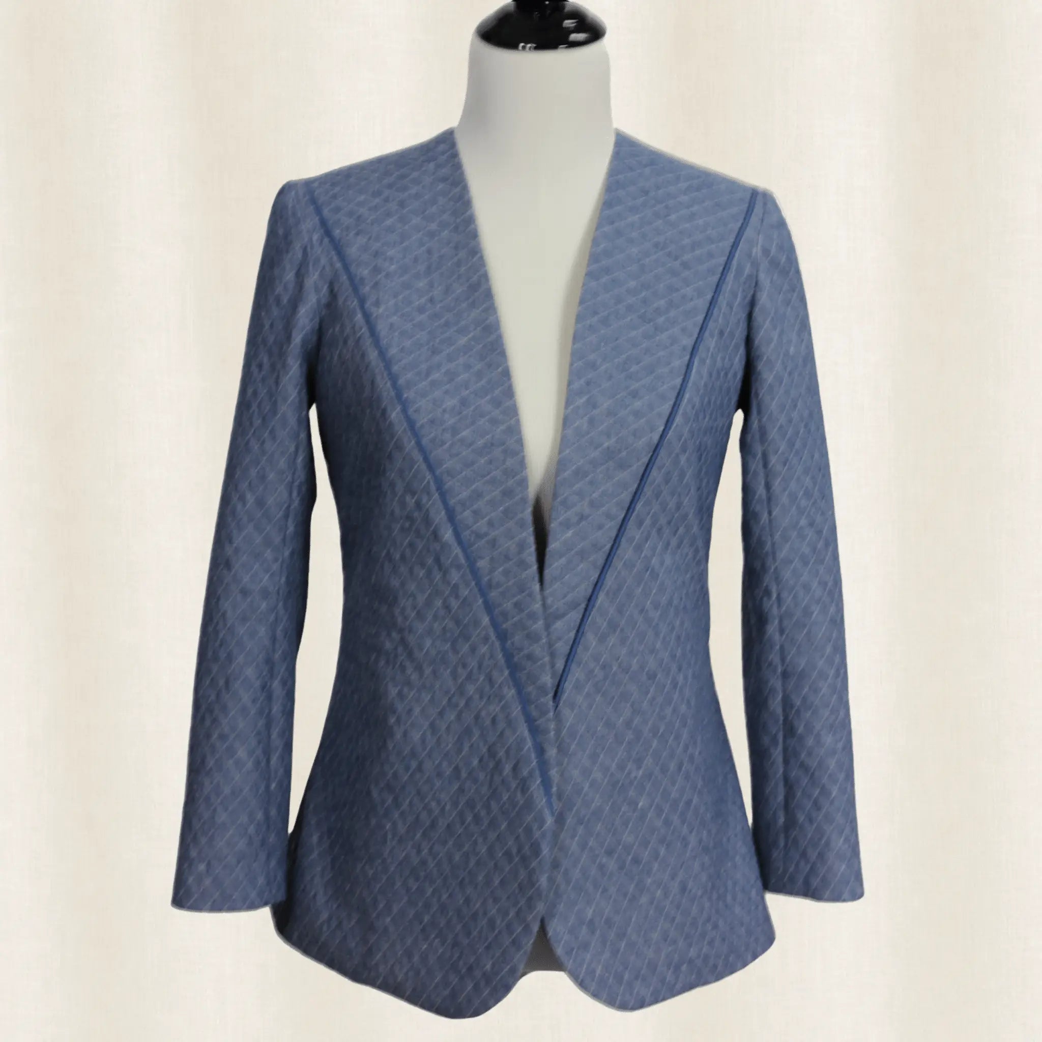 Blue patterned blazer on a mannequin against a beige background