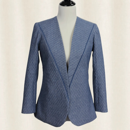 Blue patterned blazer on a mannequin against a beige background
