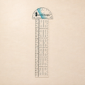 A Sure Fit Designs clear acrylic ruler with a semi-circular protractor top, shown vertically on a light beige textured background.
