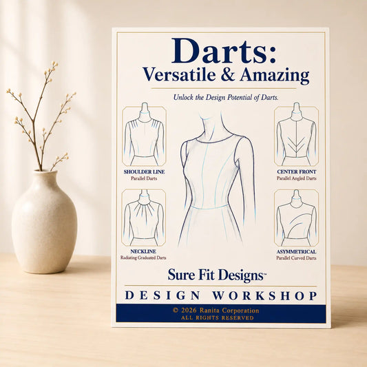 A Darts:  Versatile & Amazing course displayed on a light maple table with a small vase of branches.