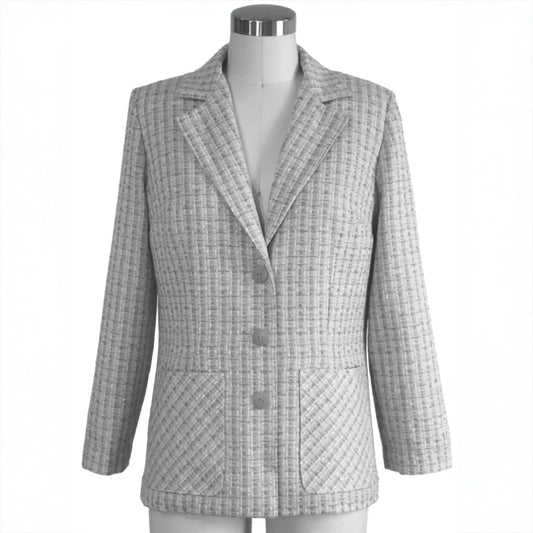 Gray checkered coat on a mannequin against a white background