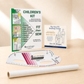 A children's sewing kit set displayed on a light wood surface, including a printed 'Children's Kit' booklet, a drafting course card, a curved ruler, and a spool of thread.