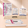 A sewing and dress-making kit laid out on a light beige surface, including a large instruction booklet, smaller course/booklets, a clear ruler, a curved measuring template, and a white fabric roll. The visible brand is Sure Fit Designs, printed on multiple items.