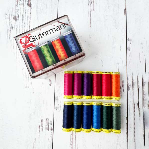 Gutermann thread set with spools on a wooden surface