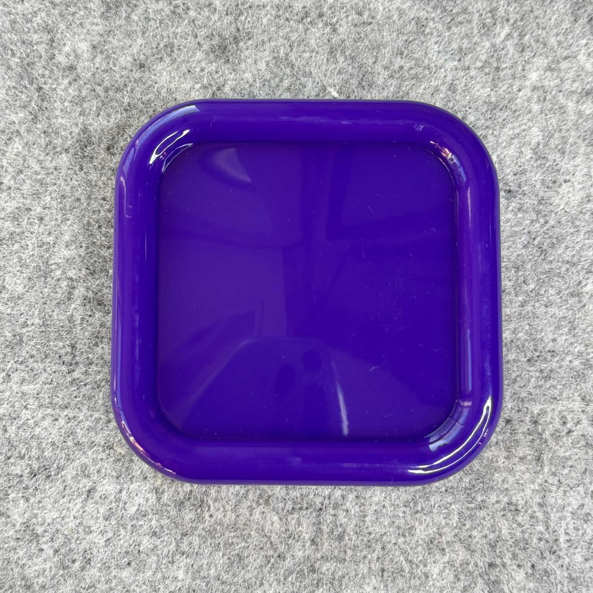Purple square plastic container on a gray surface