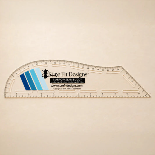 A clear plastic curved measuring ruler with printed measurement markings and the Sure Fit Designs logo, shown on a plain light beige background.