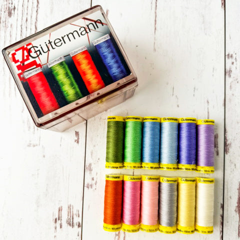 Gutermann thread set with colorful spools on a wooden surface