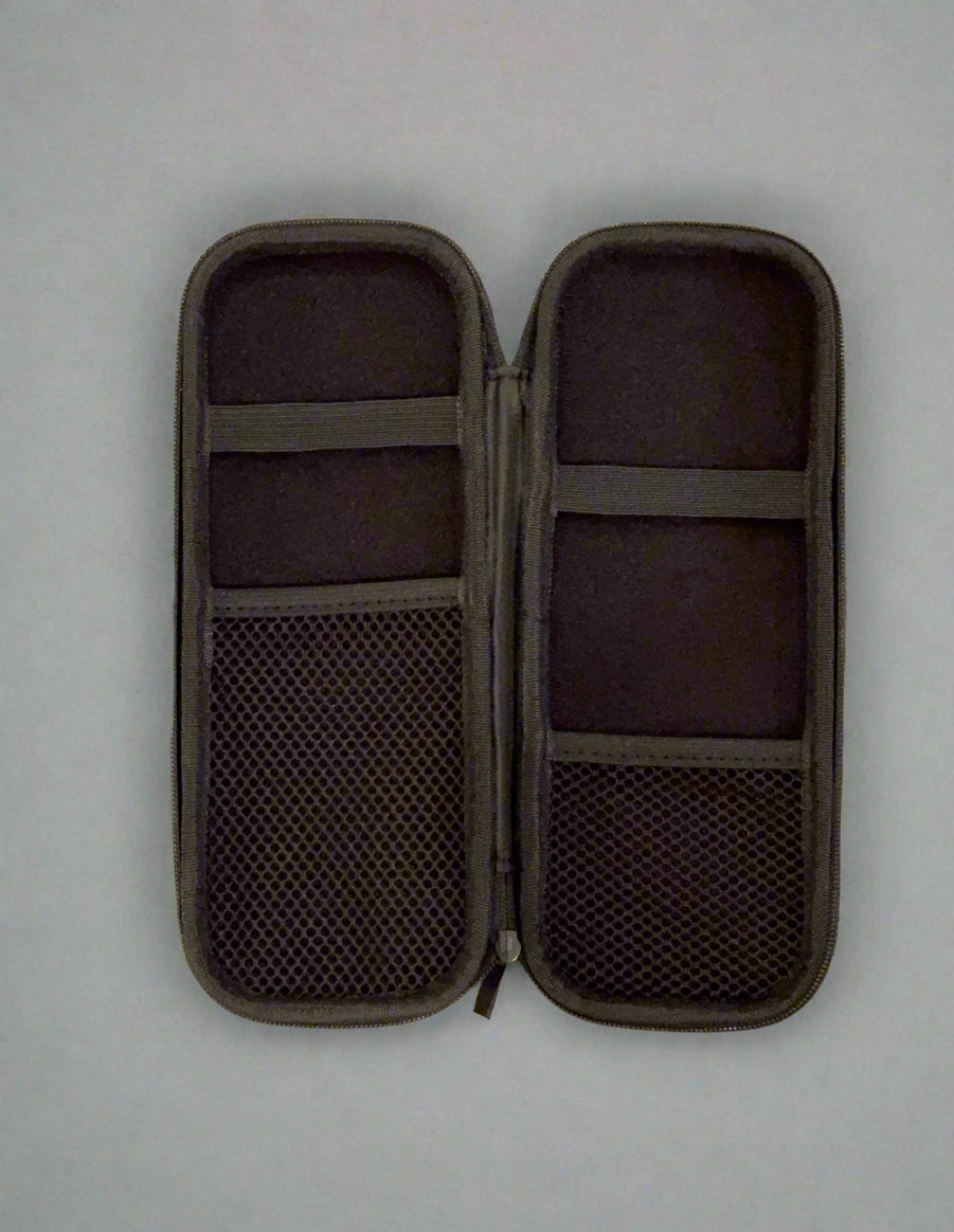 Black travel case with compartments on a beige carpet