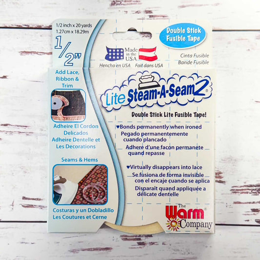 Package of Lite Steam-A-Seam 2 double stick fusible tape with branding and product details.