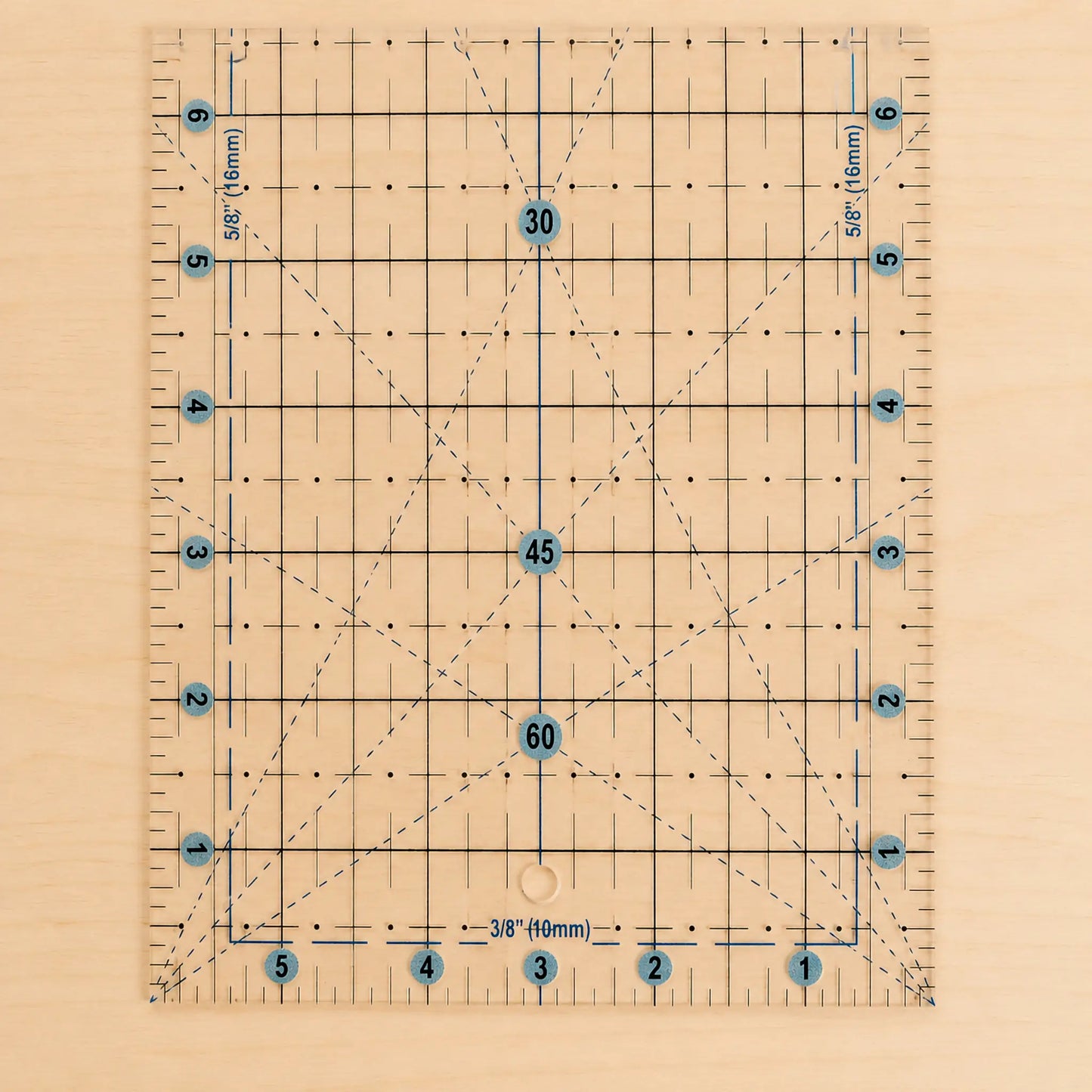 A clear acrylic quilting ruler with a light wood backing, featuring a grid system, diagonal guide lines, and blue circular markings with numbers.