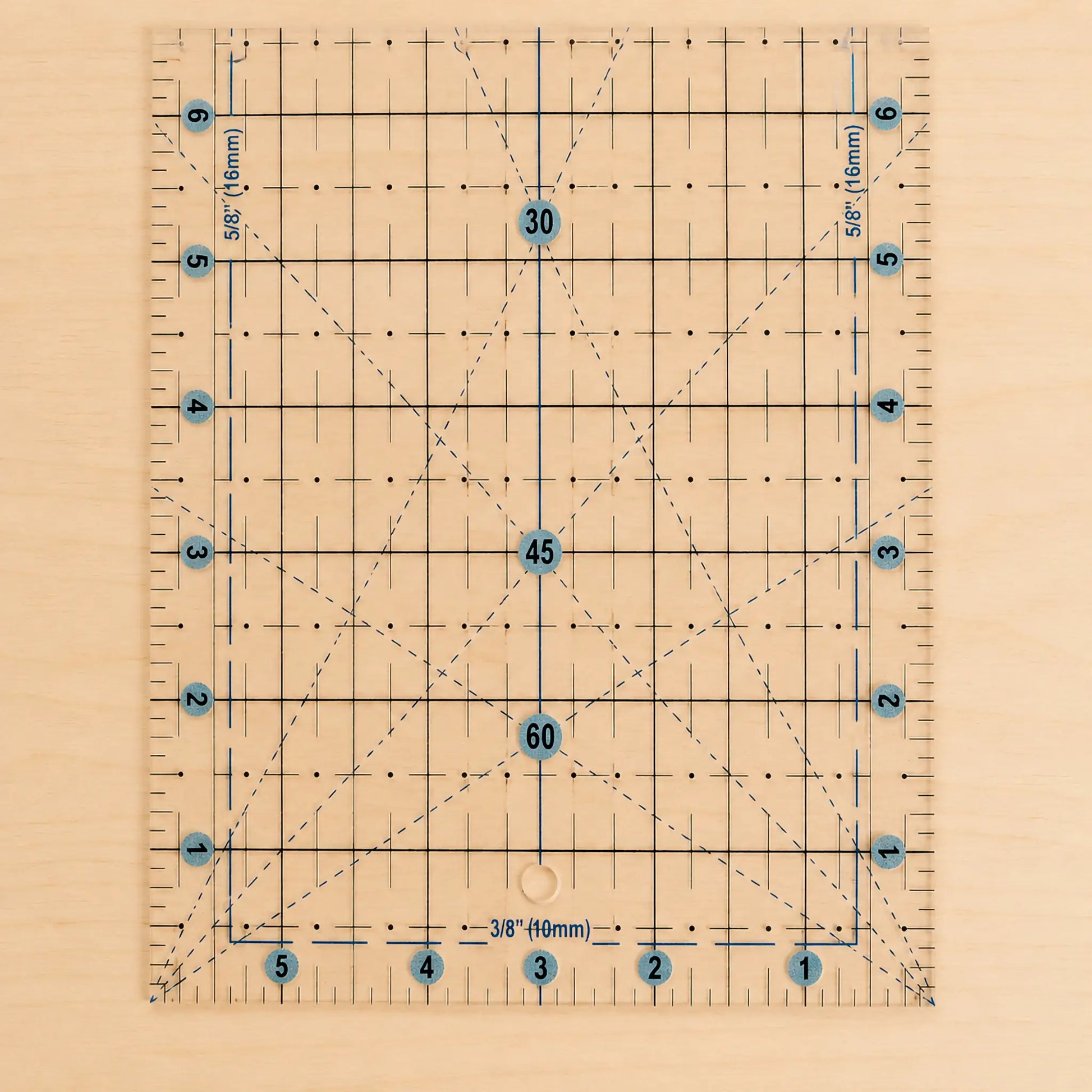 A clear acrylic quilting ruler with a light wood backing, featuring a grid system, diagonal guide lines, and blue circular markings with numbers.