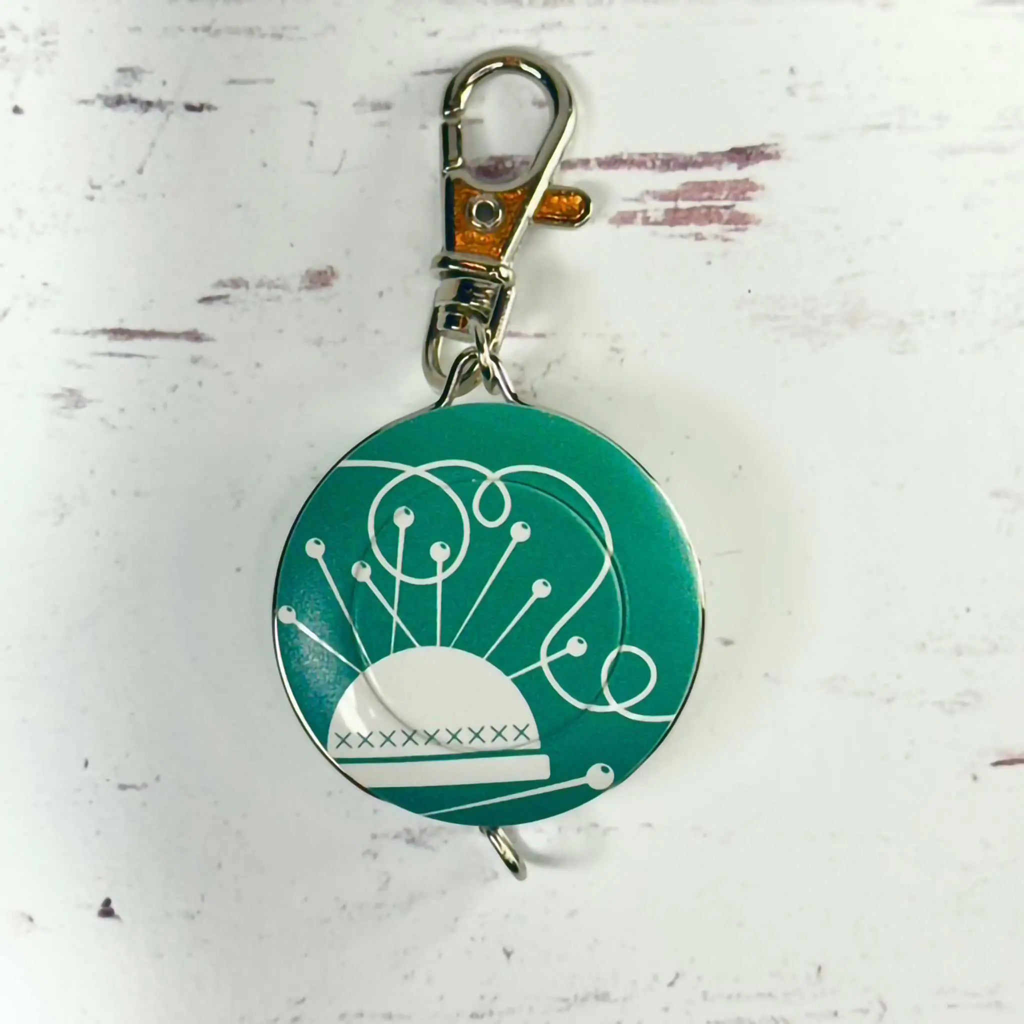 Green tape measure with white design on a white background