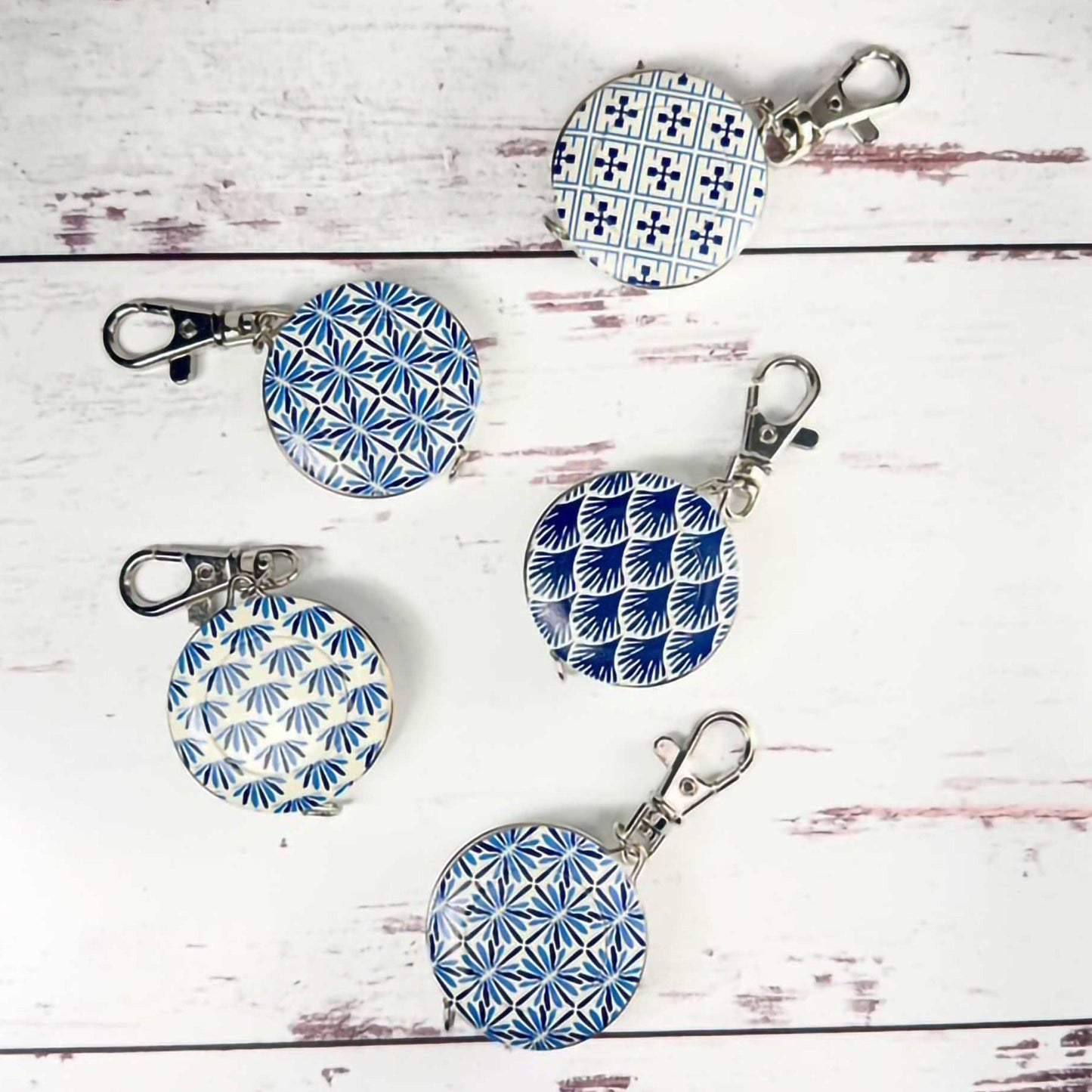 five retractable tape measure/key chains for sewing with colorful Japanese sewing themes 
