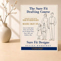 The Sure Fit Drafting Course displayed on a light maple table with a small vase of branches.