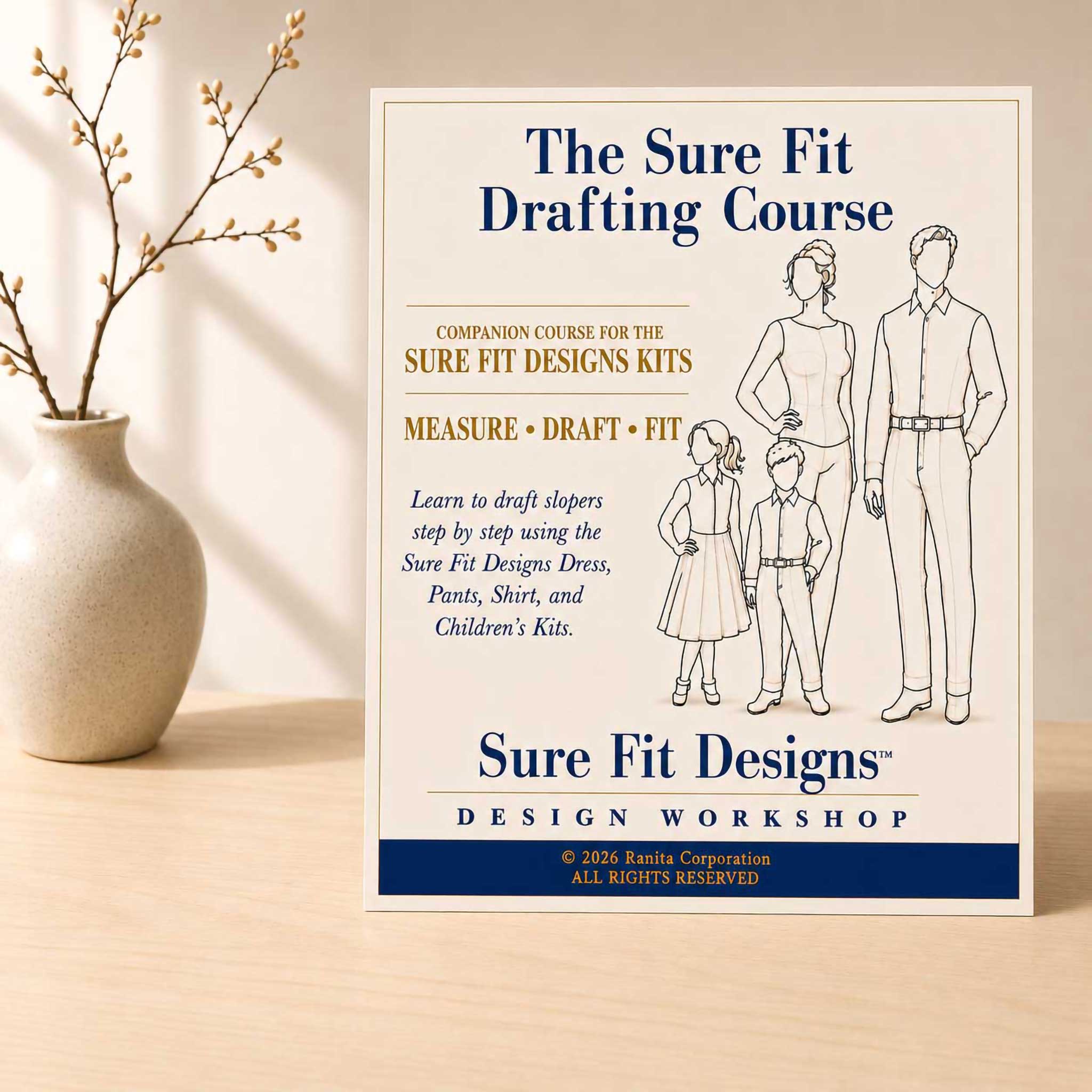 The Sure Fit Drafting Course displayed on a light maple table with a small vase of branches.
