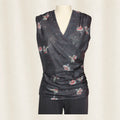 Dark gray sleeveless top with floral pattern on a mannequin against a plain background