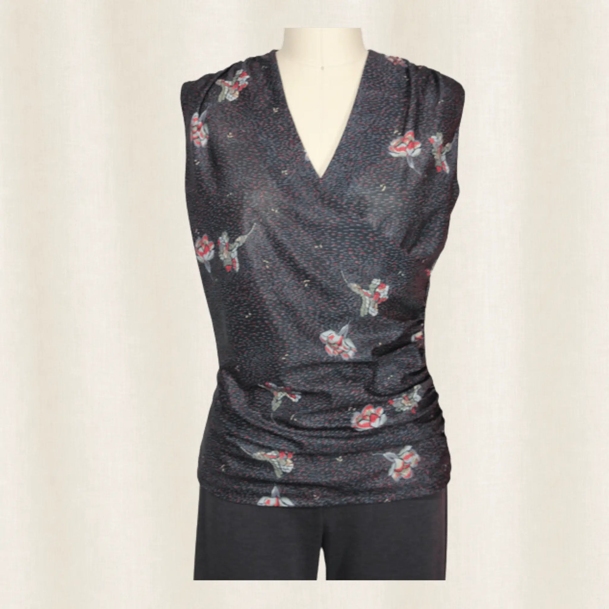 Dark gray sleeveless top with floral pattern on a mannequin against a plain background