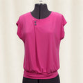 Pink blouse on a mannequin against a white background