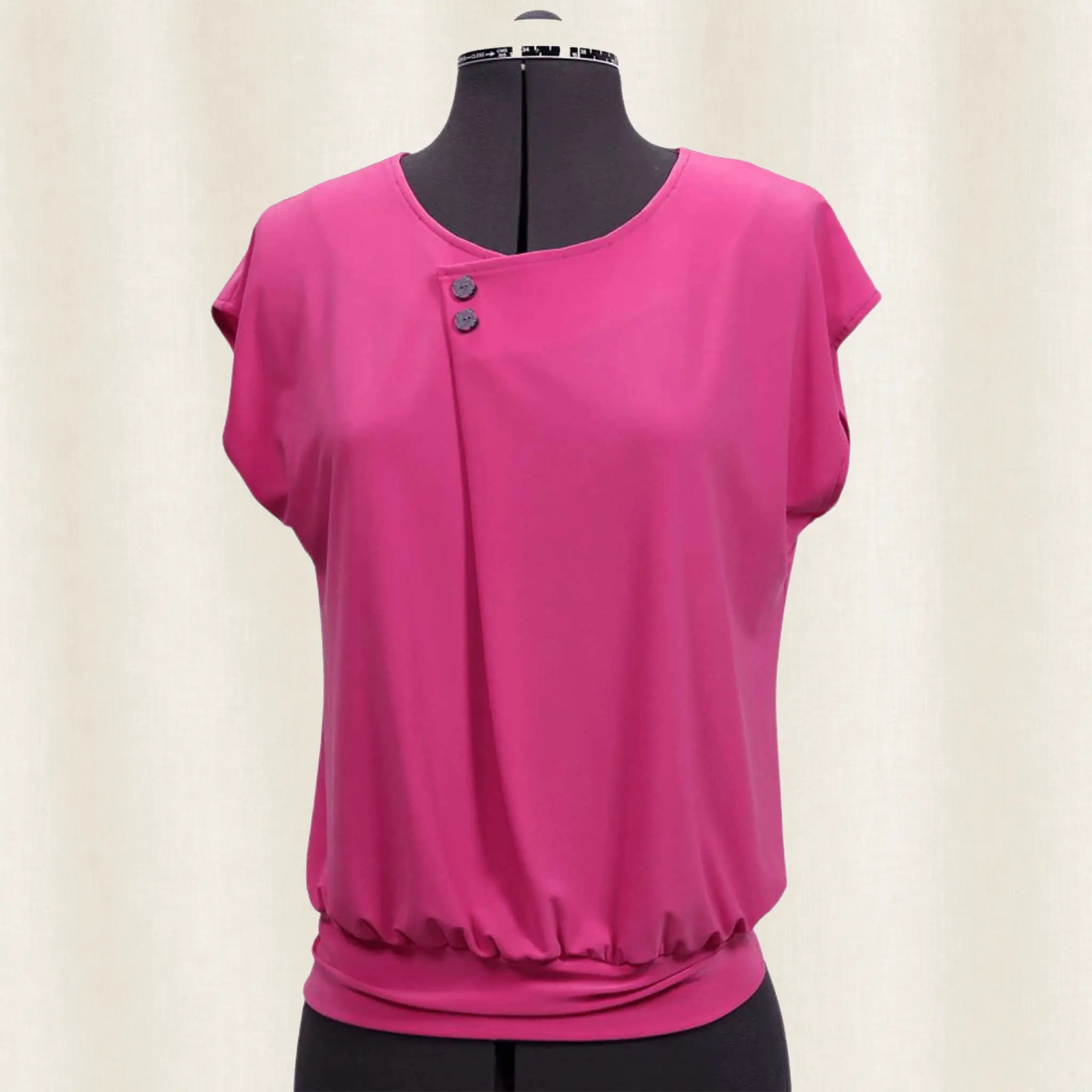 Pink blouse on a mannequin against a white background