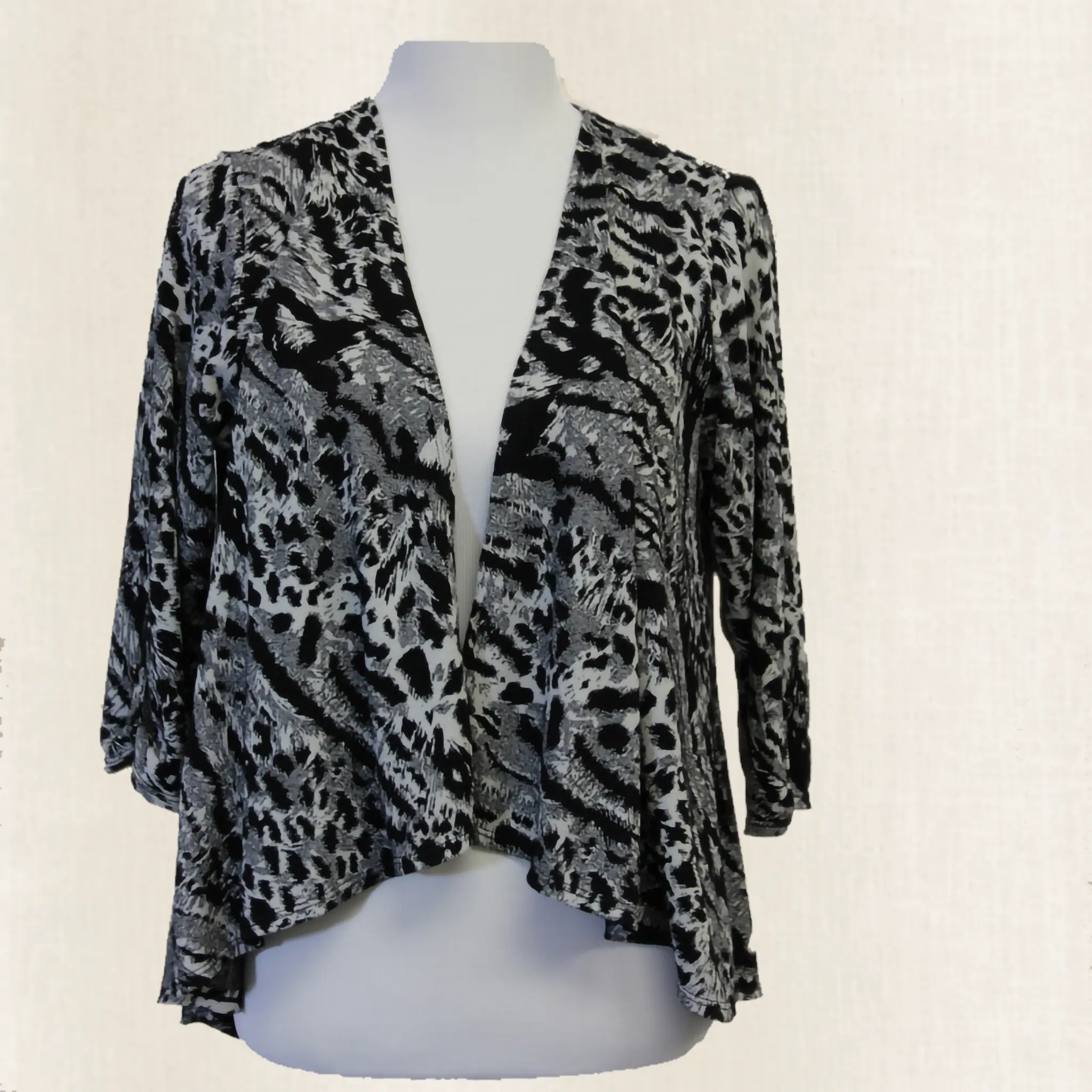 Leopard print cardigan on a mannequin against a white background