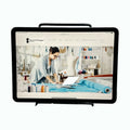 Computer screen displaying a website with a tailor working on fabric.