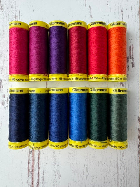 Set of colorful thread spools on a wooden surface