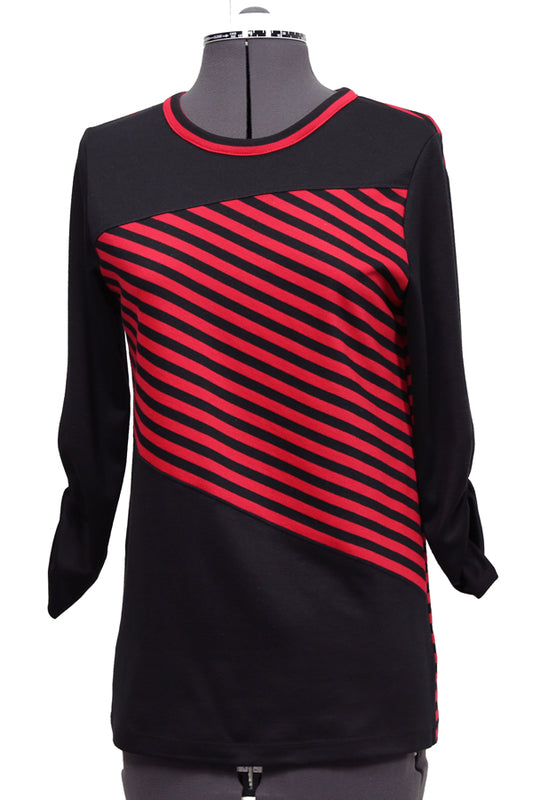 A long sleeved tunic length T shirt on a mannequin that is black with a section of red and black diagonal striped fabric over the bodice portion