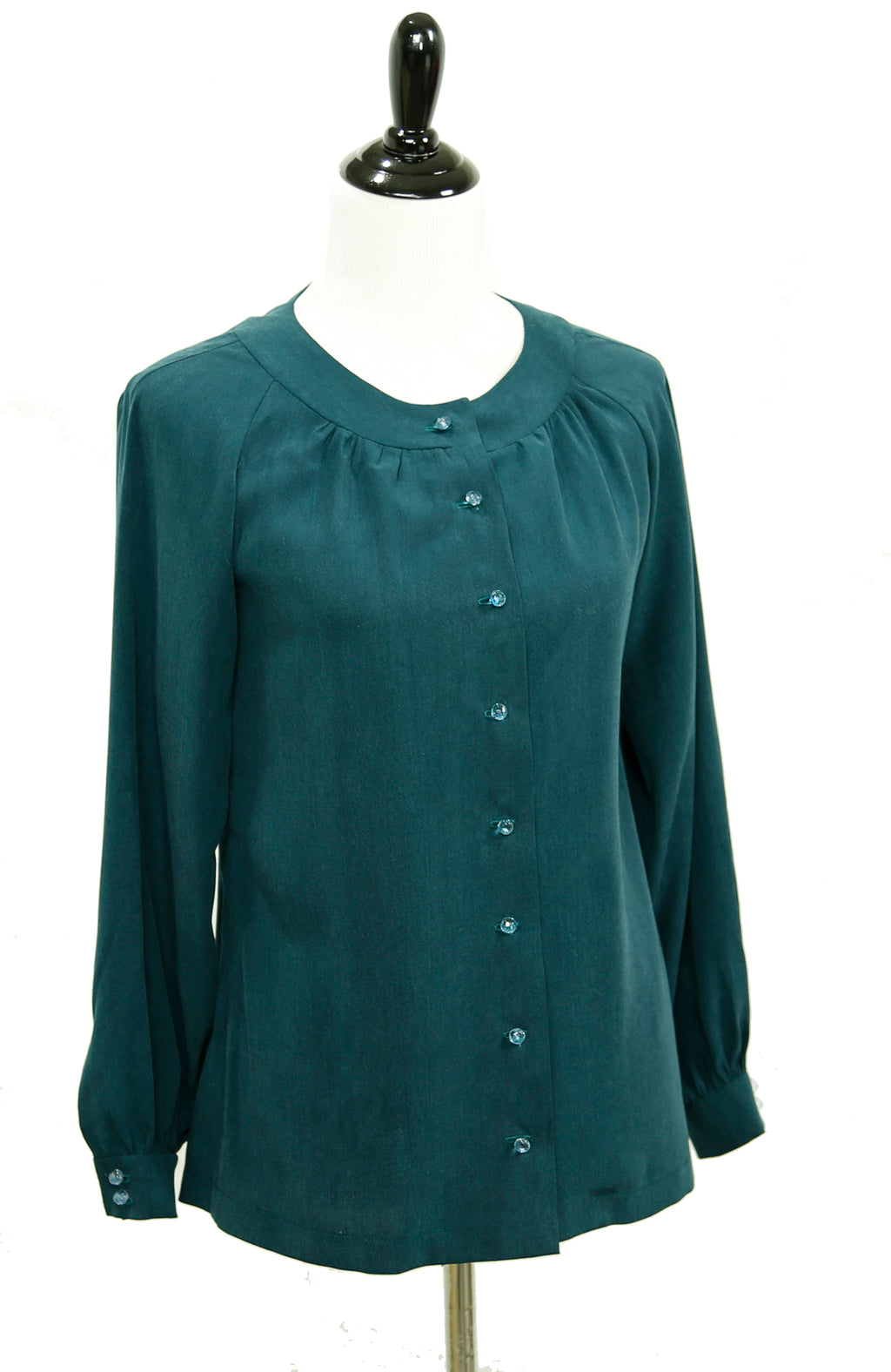 A digital sewing PDF for A long sleeved button up blouse.  the garment on the mannequin is green