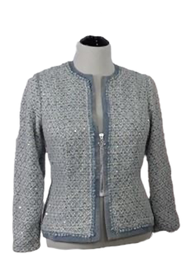 A close up of a mid zipper on a jacket made of blue brocade fabric