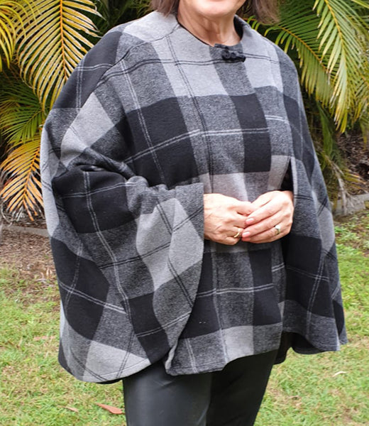 A digital PDF sewing pattern for hooded cape.  The garment is shown on a woman wearing a two-toned gray flannel cape